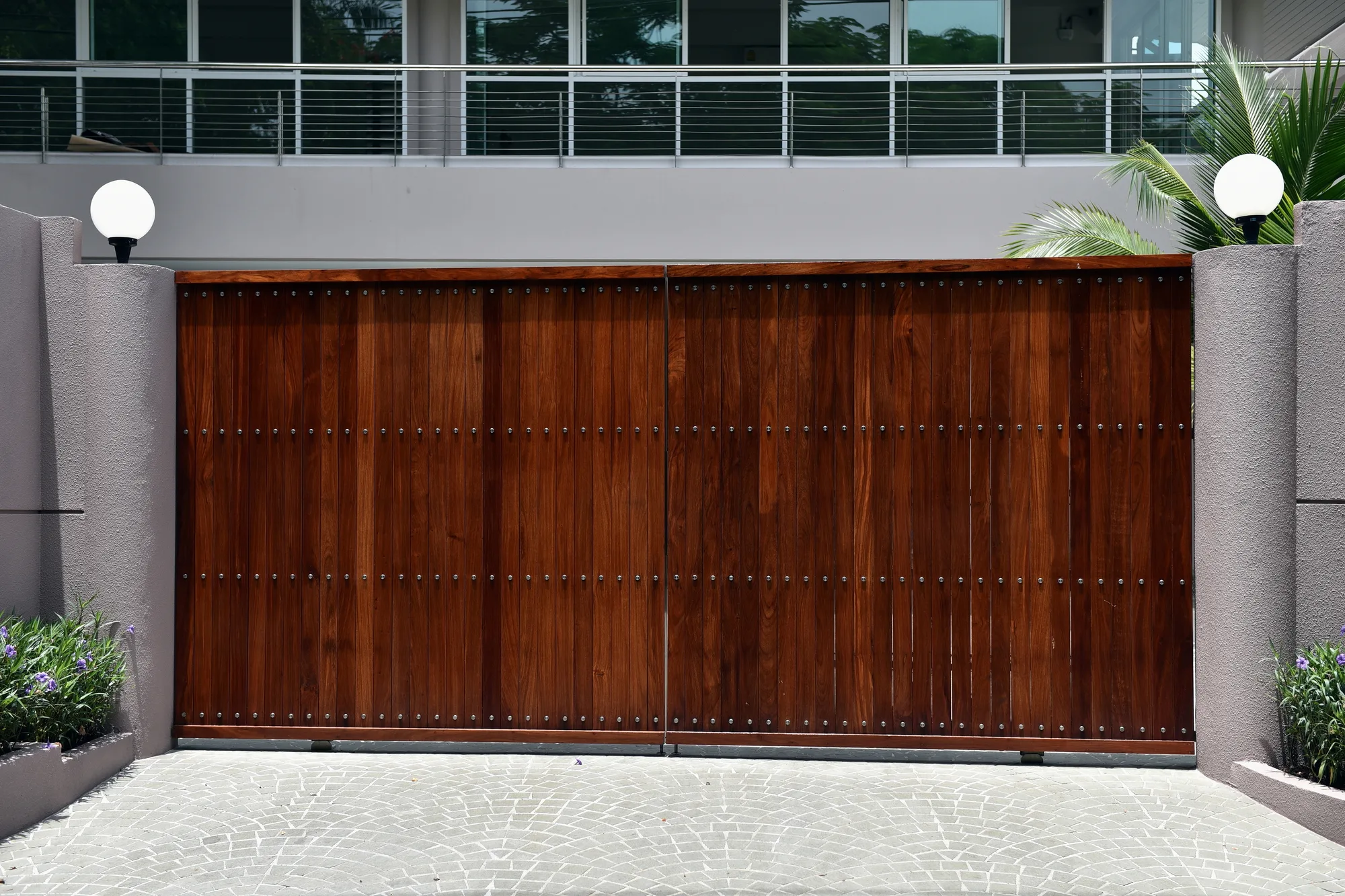 Timber double swing gate between rendered walls